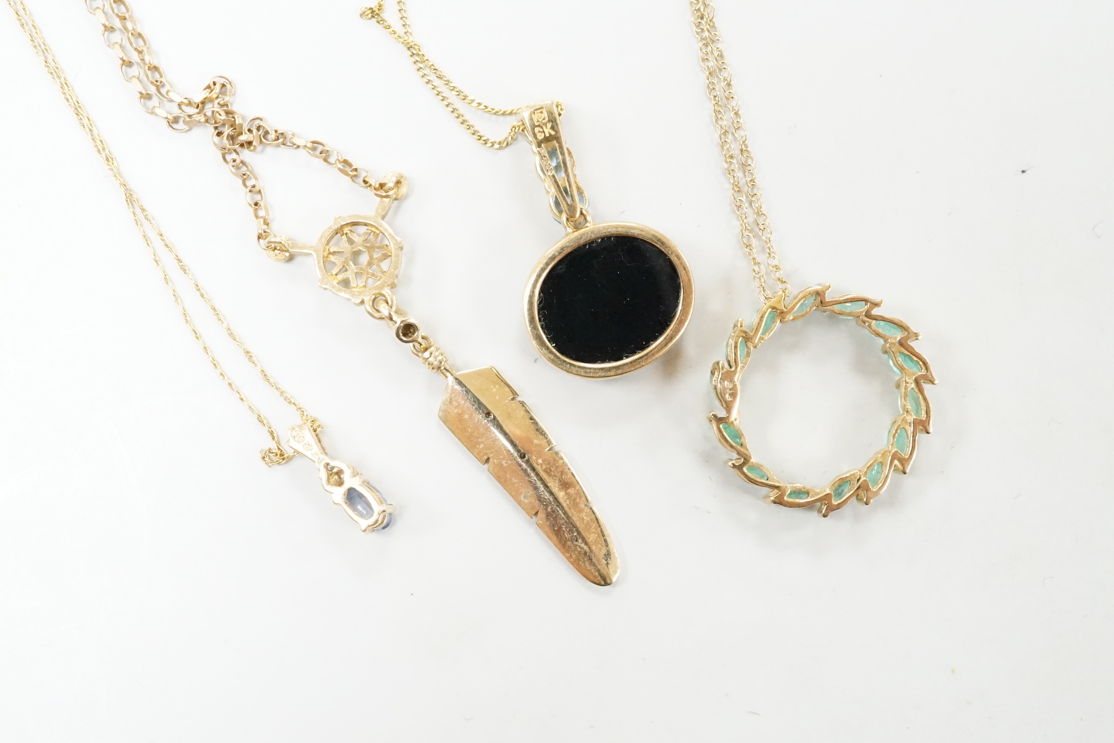 Three assorted modern 9ct or yellow metal and gem set pendants, on 9ct chains including opal doublet and blue topaz, feather shape and emerald set circular and a similar 10k pendant, on a 10k chain, longest 52cm, gross w